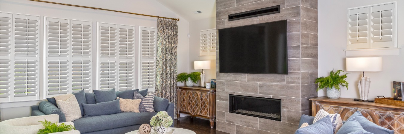 Plantation shutters in Oak Lawn family room with fireplace
